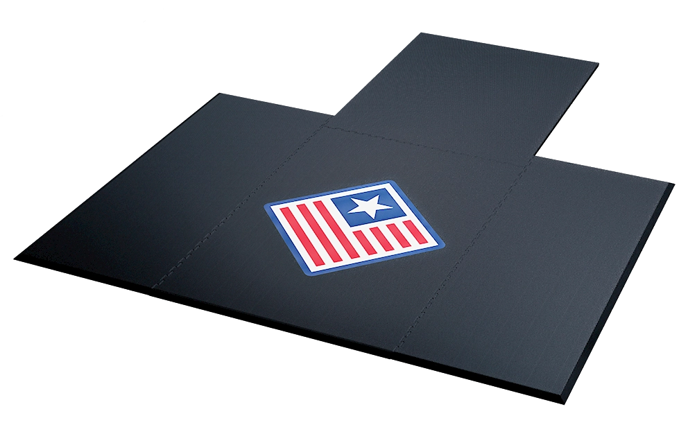 Perspective view of a low-profile black rubber lifting platform featuring a flag logo in the center, American Platforms.